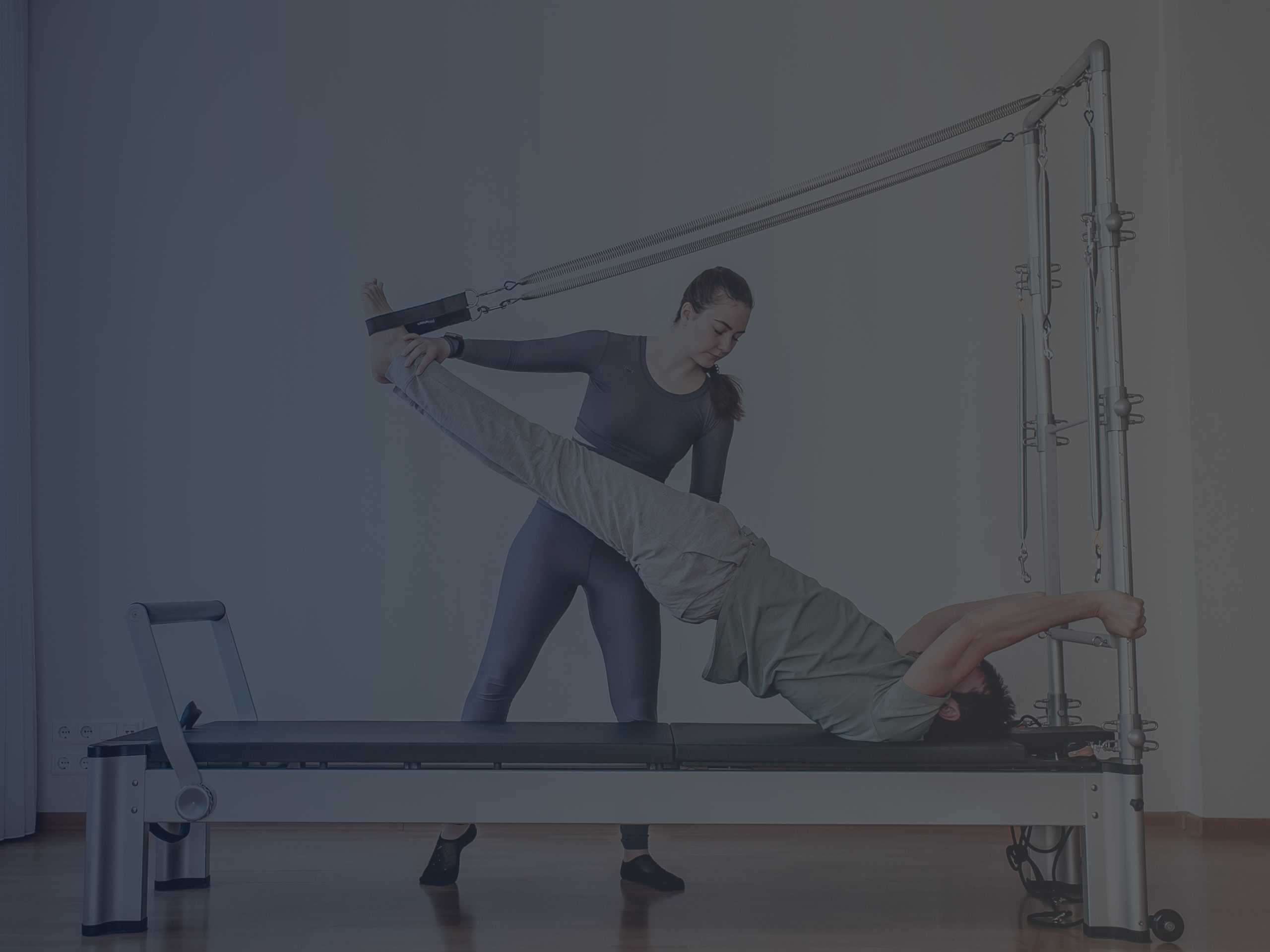 Reformer Pilates Instructor Helping Client